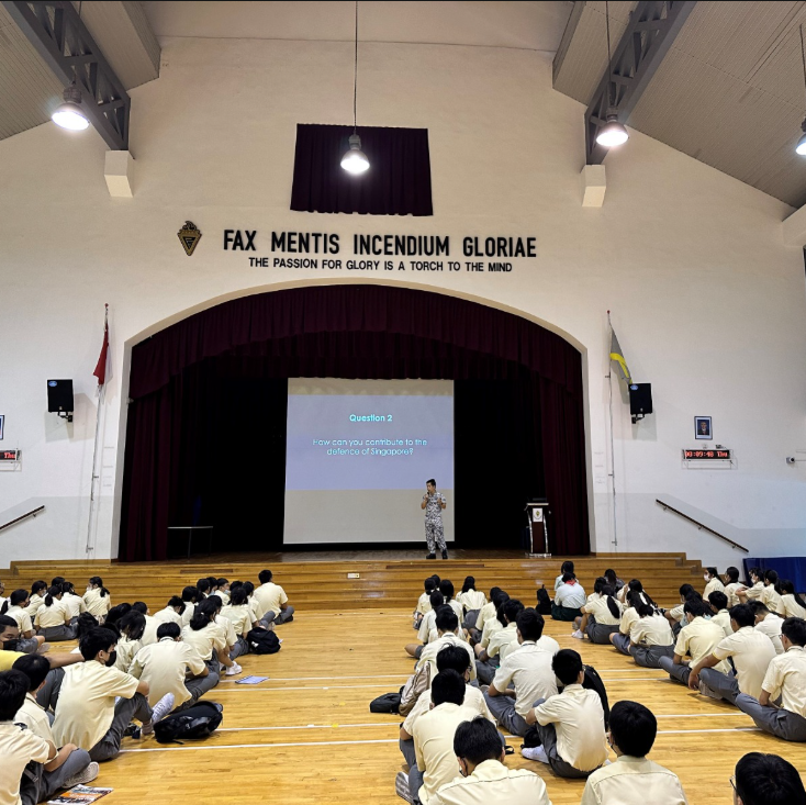 SAF officer presenting to students, discussing National Education and defence topics.
